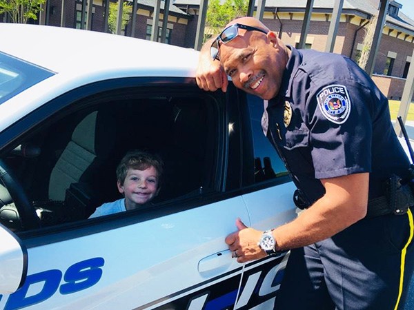 One Young Man Learns About Police Work | Lieutenant Wilbur Griffin with the Leeds Police Department is teaching one young man about police work at Leeds Primary School. Collier Cisco’s dream is to be a policeman. Collier had the opportunity to see the inside of a police car and sit in the driver’s seat.